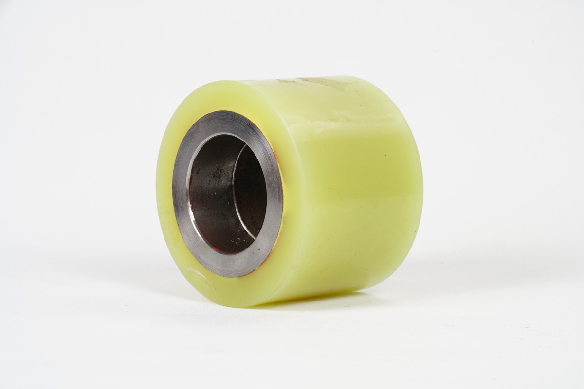 Single yellow polyurethane drive wheel close-up with steel bearing hub
